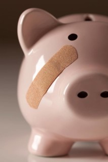 Piggy bank with bandage on face
