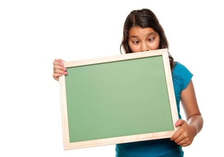 Pretty crosseyed hispanic girl holding blank chalkboard isolated on a white background