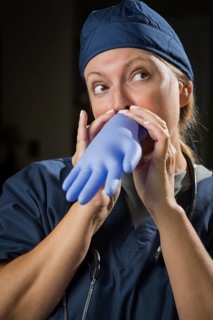 Playful funny doctor or nurse inflating surgical glove
