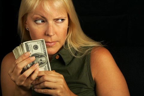 Attractive woman gets greedy about her stack of money