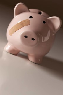 Piggy bank with bandage on face on gradated background