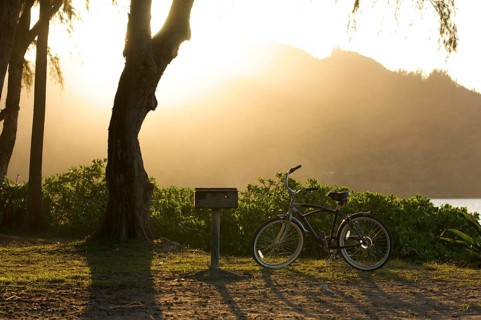 Sunset on hanalei bay with backlit bike and BBQ