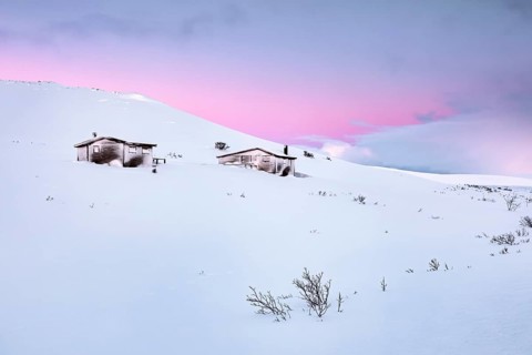 Cabins in winter landscape