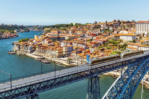 Beautiful panorama of city of Porto with metro on famous bridge
