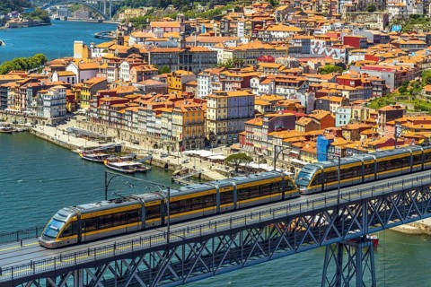 Beautiful panorama of city of Porto with metro on famous bridge