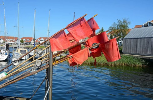 Red fishing flags at the seaside resort of Rerk