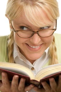 Female with ponytails reads her book isolated on a white background