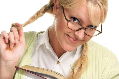 Female with ponytails reads her book isolated on a white background