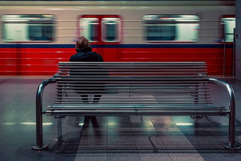 Woman sitting on the bench at metro station