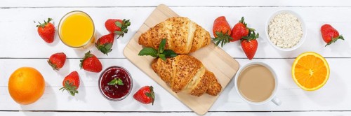 Croissant breakfast croissants food juice orange juice coffee wooden board from above banner in germany