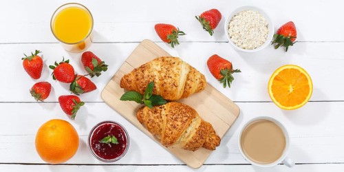Croissant breakfast croissants food juice orange juice coffee wooden board from above banner in germany