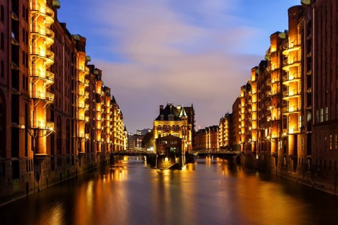 Moated castle Speicherstadt castle by night in Hamburg