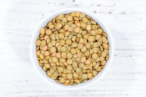 Green lentils raw from top wooden board in Germany