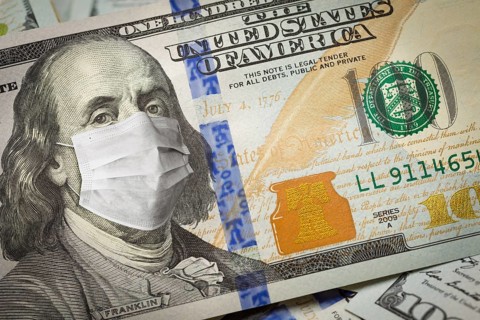 One hundred dollar bill with medical face mask on face of benjamin franklin