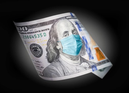 One hundred dollar bill with medical face mask on benjamin franklin