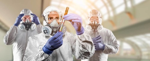 Team of doctors or nurses in hazmat gear holding positive coronavirus test tube banner