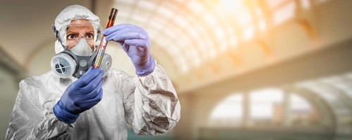 Female doctor or nurse in hazmat gear holding positive coronavirus test tube banner