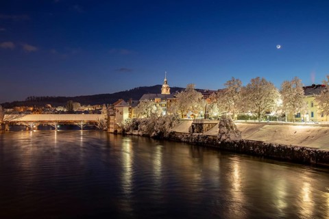 View of river Aare with wooden bridge in winter