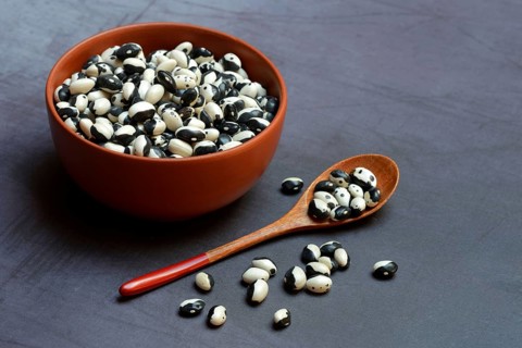 Dried beans in bowl with spoon
