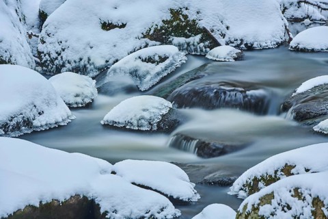 Icicles on wild river in nature reserve Hoelle