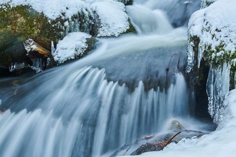 Icicles on wild river in nature reserve Hoelle
