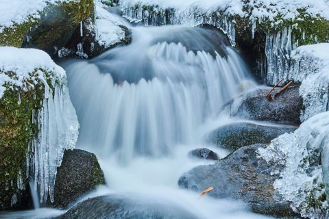 Icicles on wild river in nature reserve Hoelle