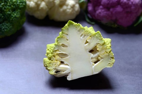Halved cauliflower Romanesco and purple and white cauliflower