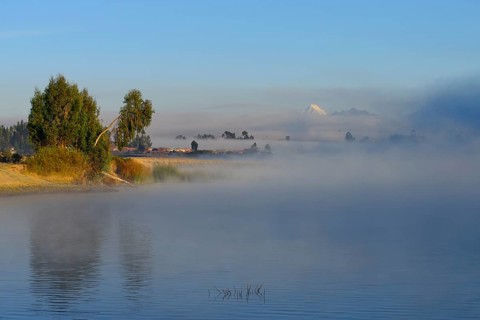 Morning fog over the lake Laguna Piuray