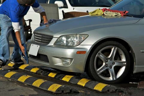 Abstract of car wash worker drying off luxury car