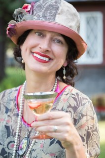 Beautiful 1920s dressed girl with glass of wine portrait