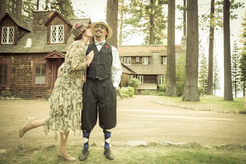 Attractive 1920s dressed romantic couple in front of old cabin portrait