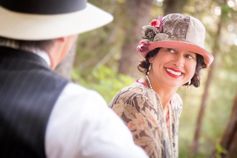 Attractive 1920s dressed romantic couple flirting outdoors