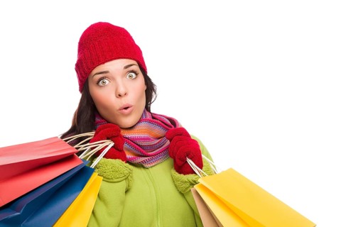 Beautiful mixed-race woman wearing winter hat and gloves isolated on a white background