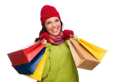 Beautiful mixed-race woman wearing winter hat and gloves isolated on a white background looking to the side