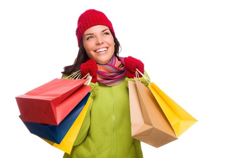 Beautiful mixed-race woman wearing winter hat and gloves isolated on a white background looking to the side