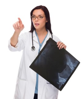 Female doctor or nurse with x-ray pushing button or pointing with room for your own button or text isolated on white