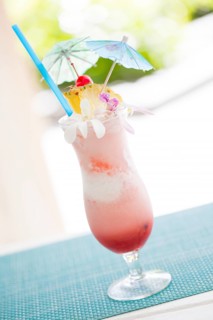 Fruity tropical drink with pineapple and umbrellas at the bar