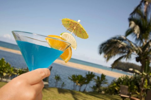Woman with tropical drinks on Lanai