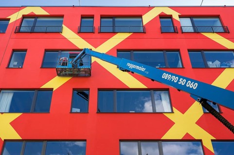 Colorful facade with window cleaners