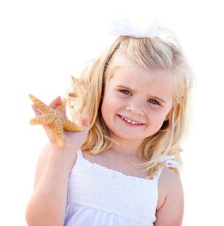 Adorable little blonde girl with starfish isolated on a white background