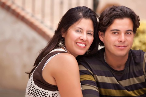 Happy attractive hispanic couple enjoying themselves at the park