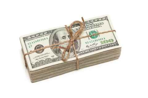 Stack of one hundred dollar bills tied in a burlap string isolated on a white background