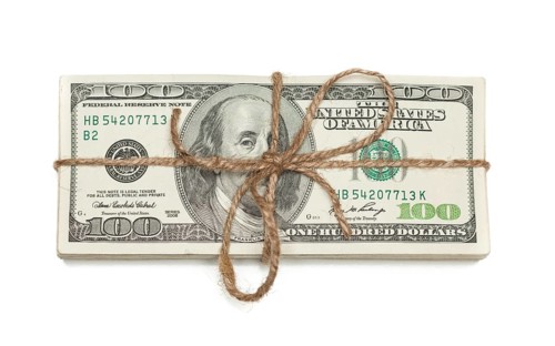 Stack of one hundred dollar bills tied in a burlap string isolated on a white background
