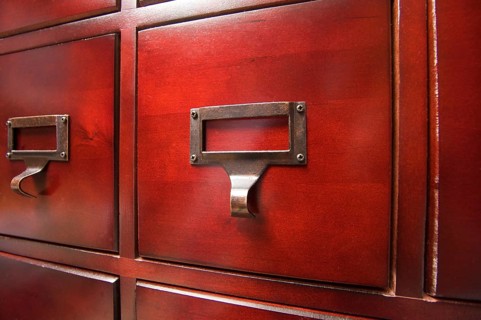 Lustrous wooden card file cabinet in dramatic light