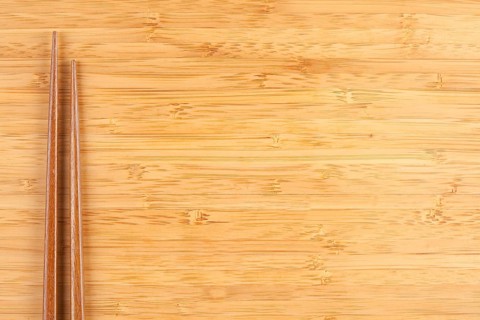 Bamboo textured surface background with chop sticks and plenty of room for text