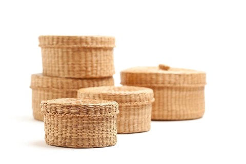 Stack of various sized wicker baskets isolated on white