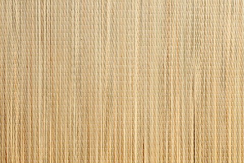 Uniform tan bamboo mat background overhead image