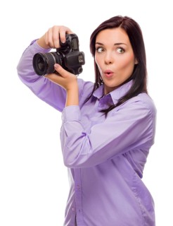 Attractive mixed-race young woman with DSLR camera isolated on a white background