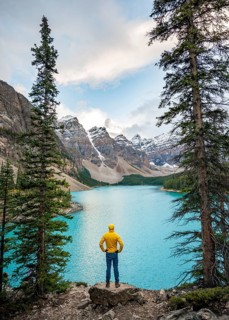 Young man standing on a rock looking into the distance