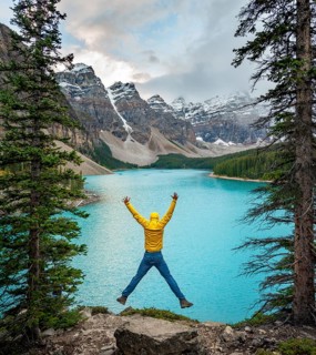 Young man jumps into the air and stretches his arms in the air